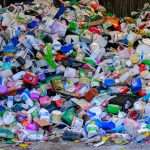 A pile of plastic bottles sitting on top of a street